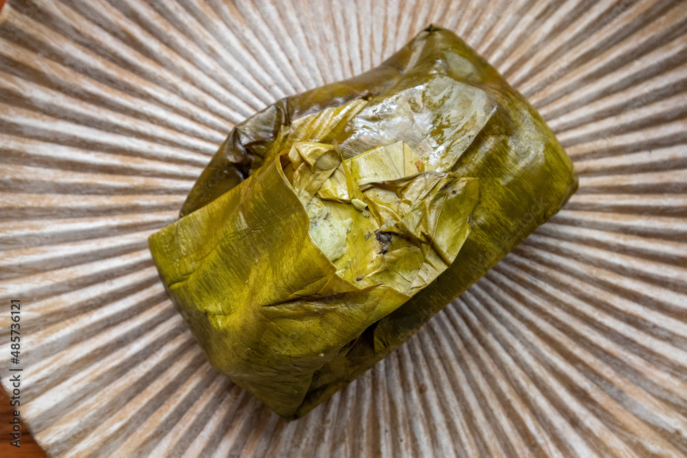 Eating Tamales in Oaxaca, Mexico. The tamale is masa filled with mole