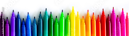 Felt-tip pens on a white background. Multi-colored markers are beautifully folded by the color of the rainbow. Creativity and design concept. photo