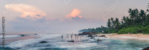 Fototapeta Stilt fishermen at sunrise at Midigama Beach, near Weligama, South Coast, Sri La