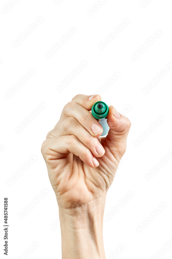 Fototapeta premium Close-up Female hand writing with a pen, green pen in hand, isolated on white background
