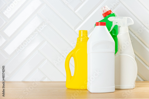 Cleaning concept. Set of cleaning detergents in colored plastic bottles. Clean house.