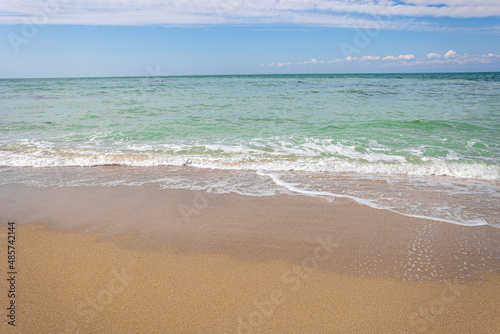 Beautiful bright colorful tropical summer background. Soft turquoise blue ocean wave on golden sandy beach.