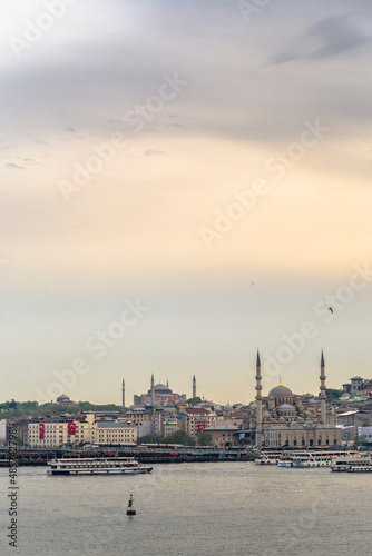 New Mosque (Yeni Cami) at sunset with Hagia Sophia (Aya Sofya) behind seen across the Golden Horn, Istanbul, Turkey, Eastern Europe, background with copy space © Matthew
