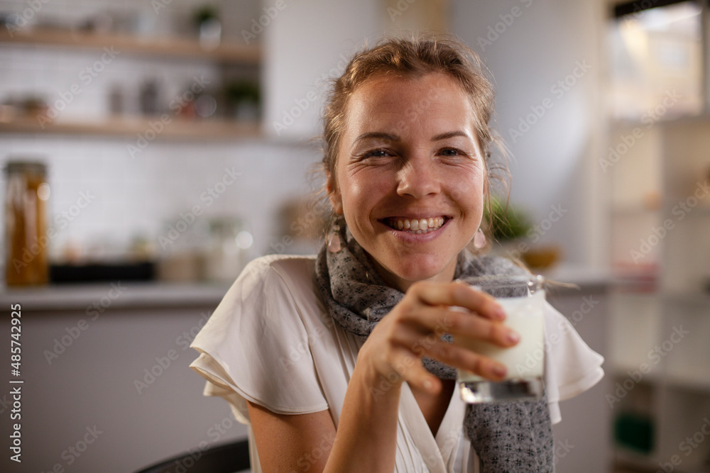 Beautiful businesswoman enjoying in breakfast. Happy young woman eating sandwich at home Beautiful businesswoman enjoying in breakfast. Happy young woman eating sandwich at home