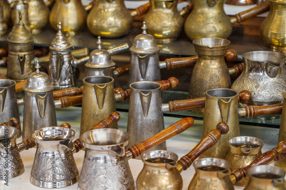 Coffee makers, Turkish coffee metal Turk cone with wooden handles, selective focus. Coffee makers, Turkish coffee metal Turk cone with wooden handles, selective focus.