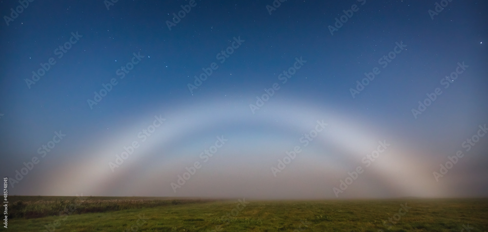 Moonbow or nocturnal rainbow at night, mystic view