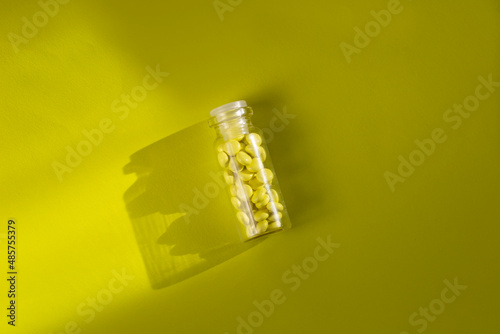 Wallpaper Mural Yellow pills in a vial on a yellow background.  Torontodigital.ca