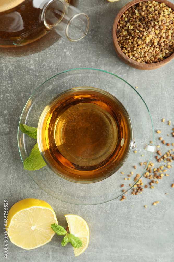 Concept of hot drink with buckwheat tea on gray textured background Concept of hot drink with buckwheat tea on gray textured background