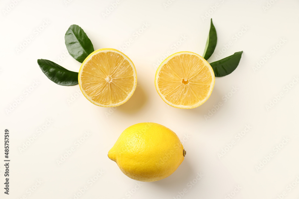 Lemons and leaves on white background, top view Lemons and leaves on white background, top view