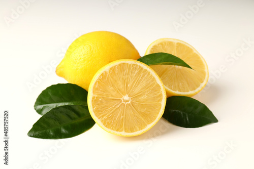 Lemons and leaves on white background, close up