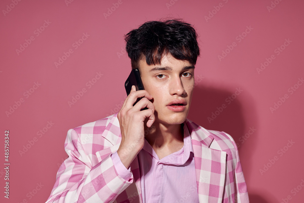 Photo of romantic young boyfriend with a phone in hand pink blazer fashion elegant style Lifestyle unaltered Photo of romantic young boyfriend with a phone in hand pink blazer fashion elegant style Lifestyle unaltered