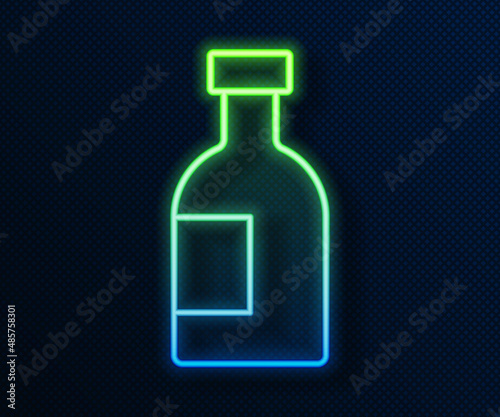 Glowing neon line Glass bottle of vodka icon isolated on blue background. Vector