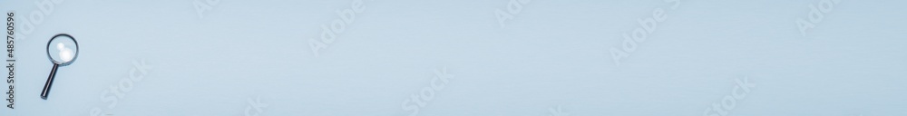 Banner with magnifying glass on a blue background with a place for text: finding 