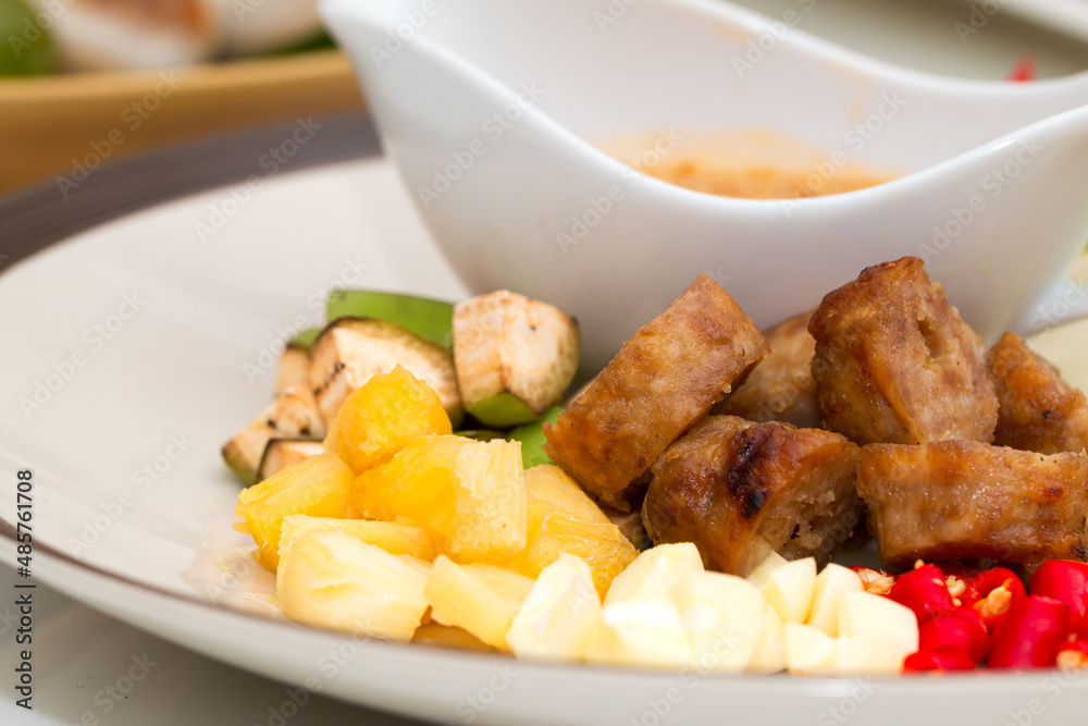 Vietnamese healthy food set; Close up of Namnueng with sliced banana pine apple chilli and dipped sauce on white plate Vietnamese healthy food set; Close up of Namnueng with sliced banana pine apple chilli and dipped sauce on white plate