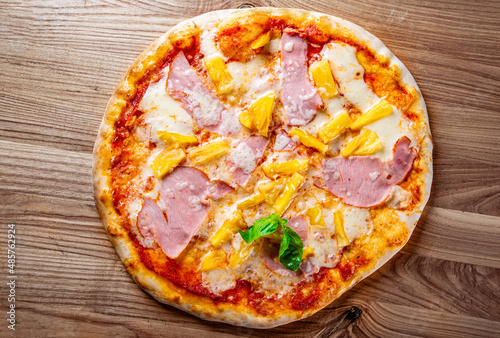 fast food. Hawaiian pizza with pineapple, ham, chicken, cheese, and vegetables