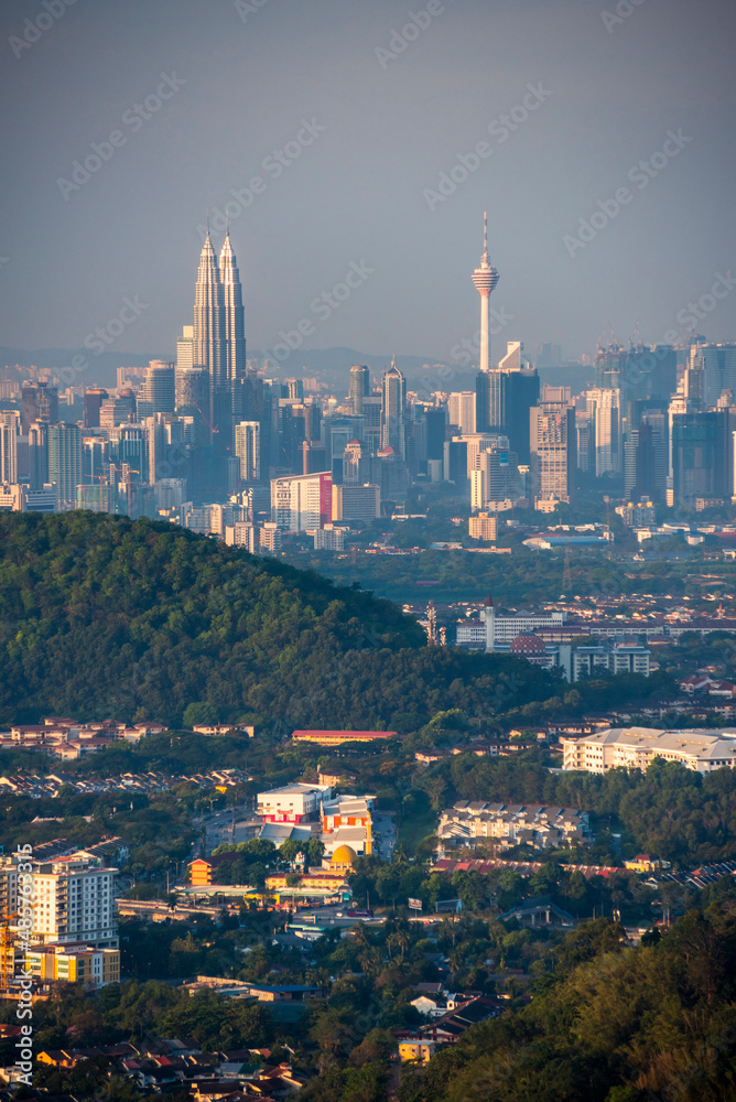 Fototapeta premium Kuala Lumpur skyline seen at dawn from Bukit Tabur Mountain, Malaysia, Southeast Asia