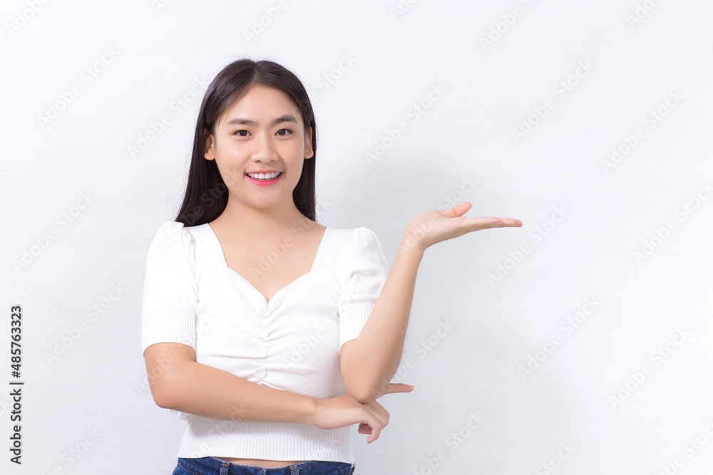 Portrait Asian woman is smiling and shows her hands to present something on the white background. Portrait Asian woman is smiling and shows her hands to present something on the white background.