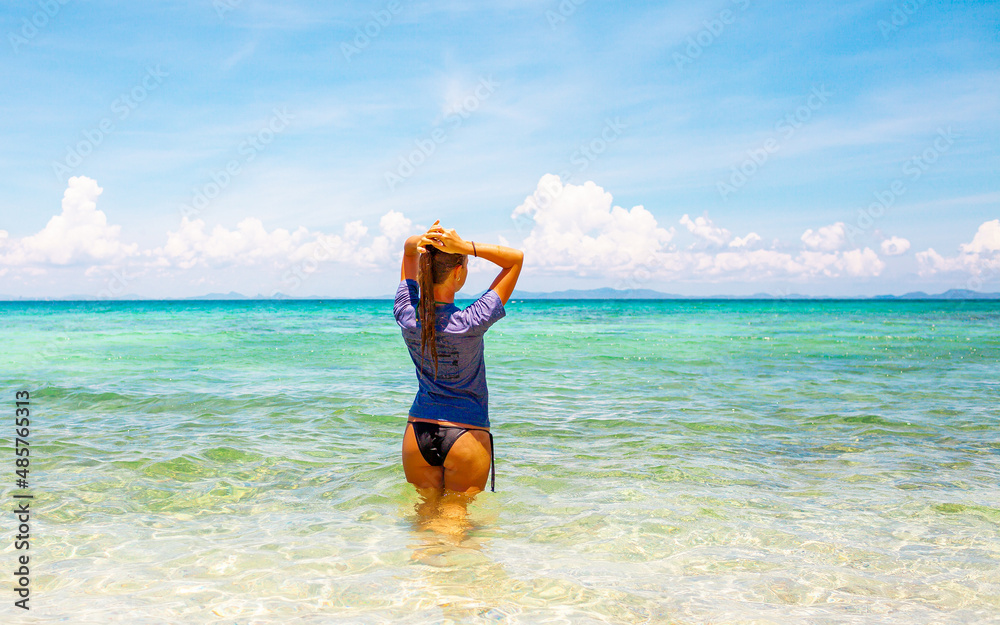 Young attractive blonde girl with perfect sport body in bikini on the tropical summer beach Young attractive blonde girl with perfect sport body in bikini on the tropical summer beach