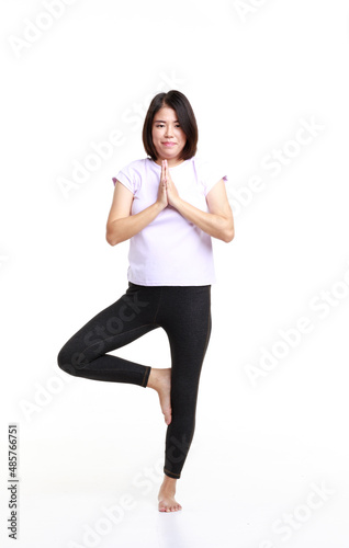 Portrait studio isolated cutout full body shot of Asian professional female yoga model in sport wears standing smiling look at camera exercise stretching body put hands together on white background