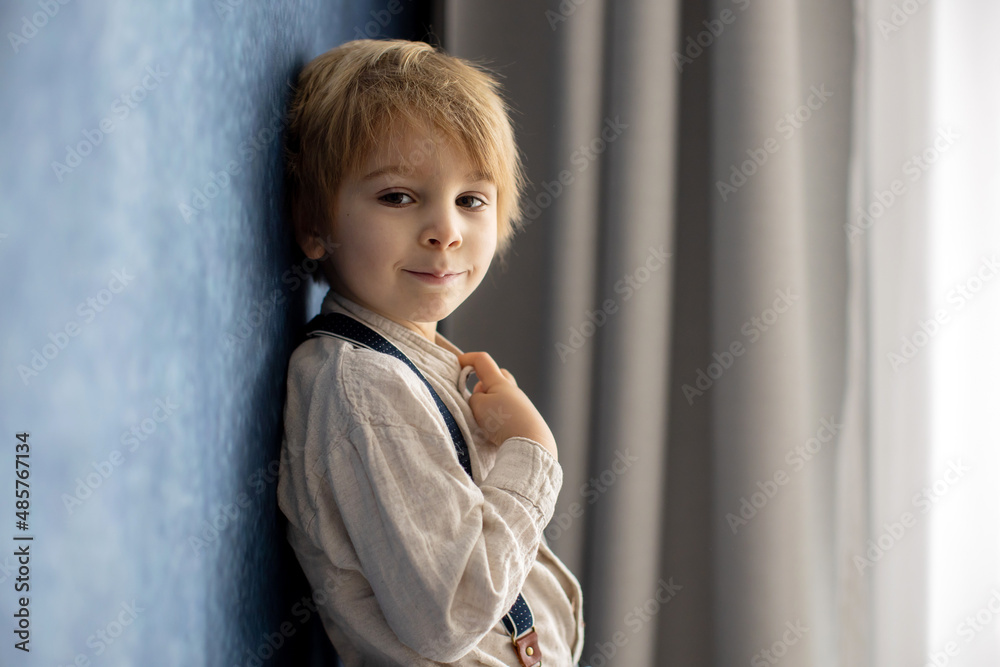 Cute portirait of blond preschool child, boy, on blue background Cute portirait of blond preschool child, boy, on blue background