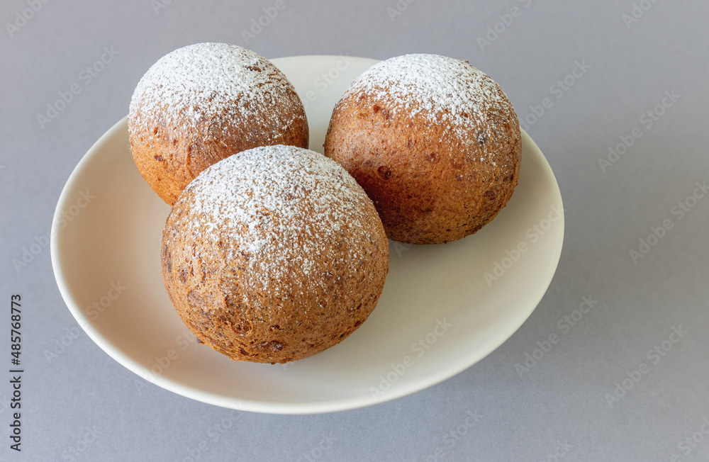 Large Lithuanian donuts on a plate against a gray background Large Lithuanian donuts on a plate against a gray background