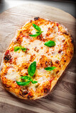 flatbread roman Pizza with Mozzarella cheese, Tomatoes, pepper, Spices and Fresh Basil. Italian pizza. Pizza Margherita or Margarita on wooden background