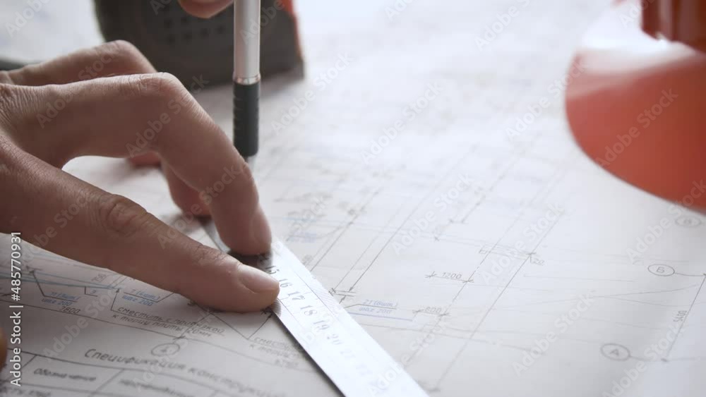 Process of making adjustments to working drawings. Hand of an engineer