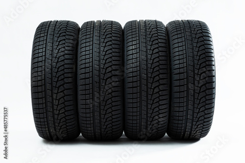 Obraz na płótnie Winter tires with structured adhesion surface in line. New black car rubbers in studio shot. Dark unused wheels for safety drive. w salonie
