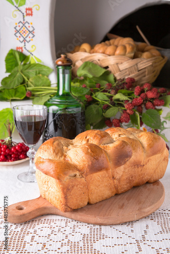 Homemade fragrant bread from the oven. National Moldavian, Romanian, or Ukrainian cuisine. Traditional dishes in an authentic interior.