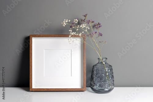Cuadro en lienzo Blank square frame with passepartout mockup over grey wall with dry flowers decorations
