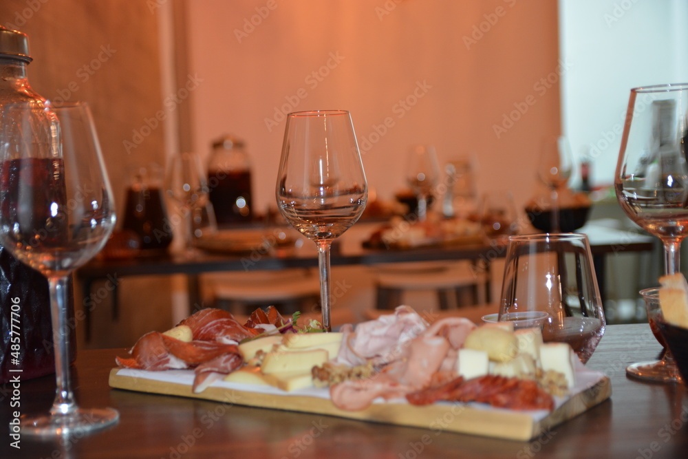 Cutting board with prosciutto, salami, cheese,bread and olives on dark wooden background.details of selected sliced meat.