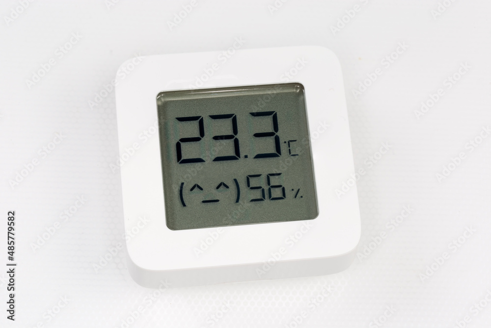 Digital indoor mini thermometer with hygrometer on a white surface Digital indoor mini thermometer with hygrometer on a white surface