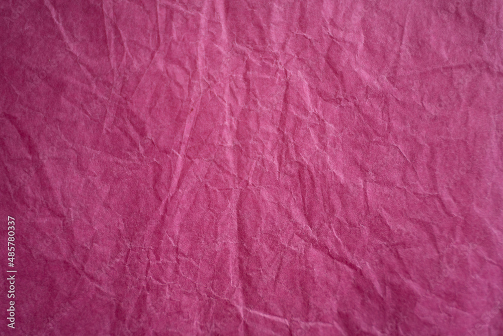 an empty hot pink wrinkled tissue paper textured background