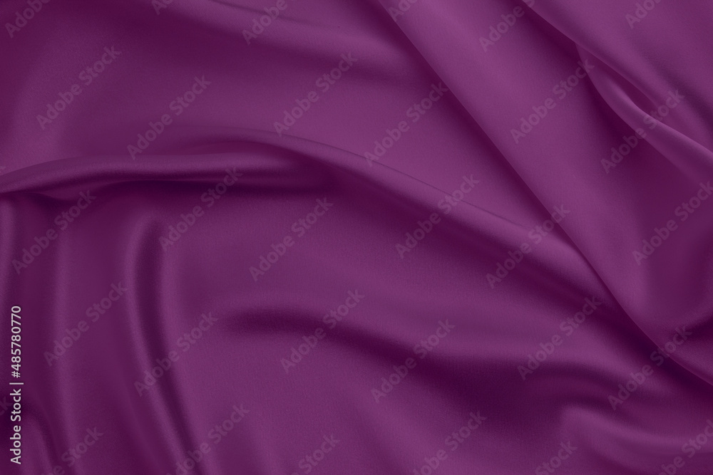 Fototapeta premium Purple silk satin background. Soft wavy folds on smooth, shiny fabric. Top view. Luxury background with copy space for design.