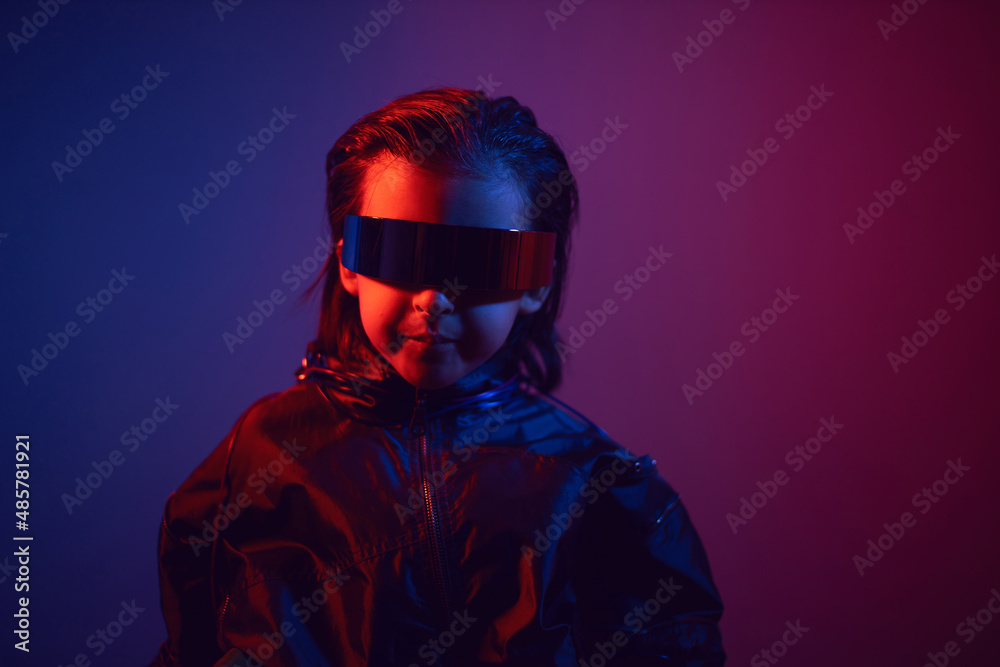 portrait cyberpunk boy child in vr glasses in blue and red tones with wires on a red background