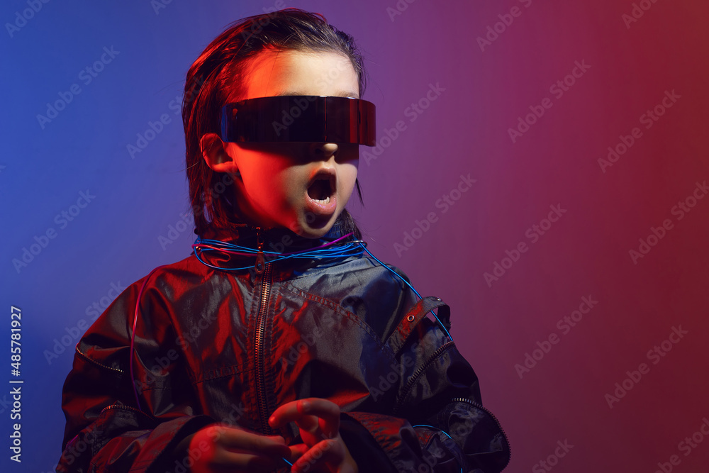 portrait cyberpunk boy child in vr glasses in blue and red tones with wires on a red background