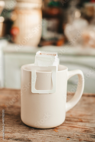 coffee in a drip bag, in a white cup, close-up