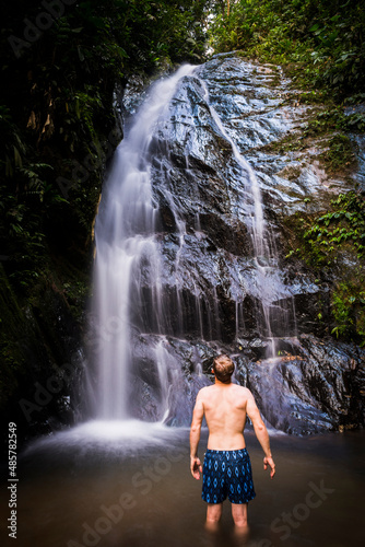 Tourist under Cucharillos Waterfall in the Choco Rainforest  Ecuador