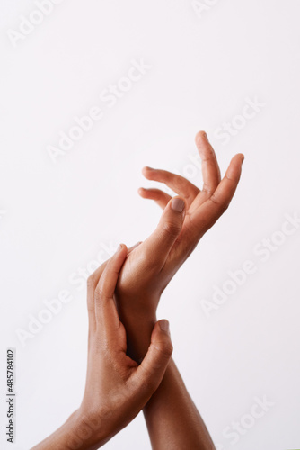 My hands feel super soft. Studio shot of an unrecognizable womans hands against a white background.