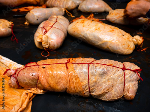 Pork loins prepared and sausages and tied with red ropes during a day of slaughter for their smoked back and ready for consumption, typical bierzo product