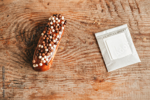 drip pack with coffee and eclair with balls on a wooden background, top view