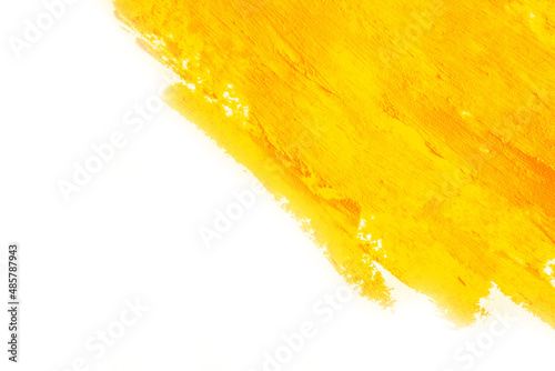 Smear of yellow paint on a white background. Cosmetics, makeup. Isolated template for design. Golden