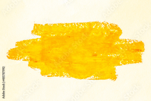 Smear of yellow paint on a white background. Cosmetics, makeup. Isolated template for design. Golden