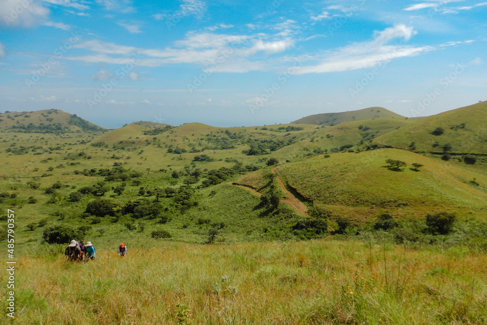 Rear view of a group of hikers at the panoramic mountain landscapes at Chyulu Hills, Chyulu Hills National Park, Kenya