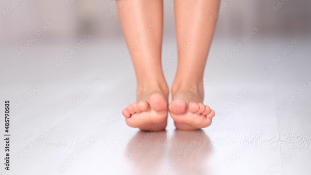 child rolls from heel to toe. Prevention of flat feet in children. Exercises for the legs. Flat feet physical therapy. close up child rolls from heel to toe. Prevention of flat feet in children. Exercises for the legs. Flat feet physical therapy. close up