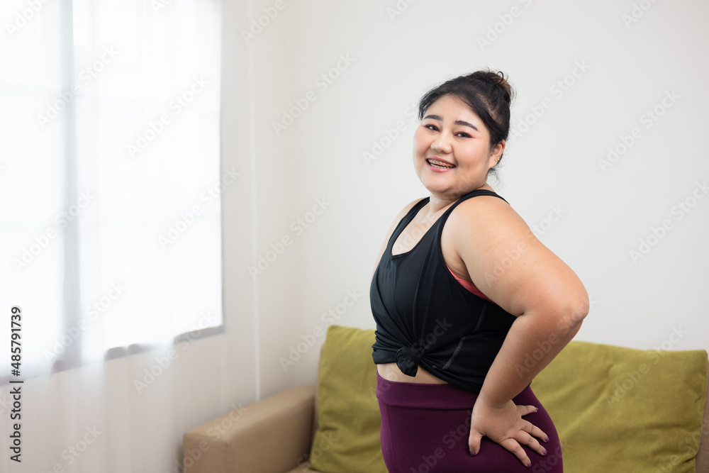 Smiling young asian women plus size standing pose looking camera. Happy lifestyle and proud herself. Sporty female in sportswear relaxing after workout. Smiling young asian women plus size standing pose looking camera. Happy lifestyle and proud herself. Sporty female in sportswear relaxing after workout.