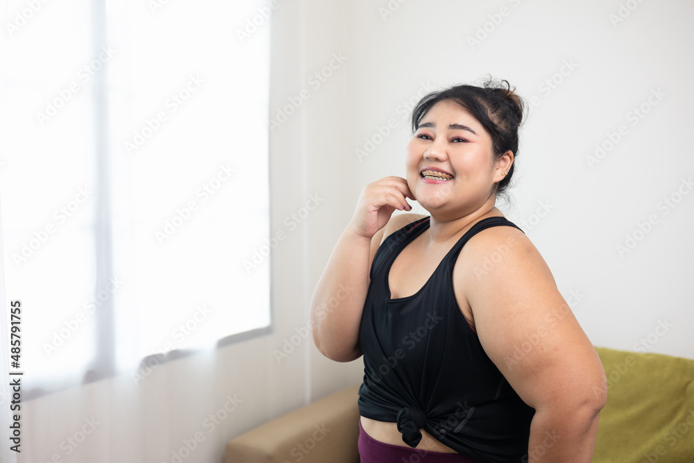 Smiling young asian women plus size standing pose looking camera. Happy lifestyle and proud herself. Sporty female in sportswear relaxing after workout. Smiling young asian women plus size standing pose looking camera. Happy lifestyle and proud herself. Sporty female in sportswear relaxing after workout.