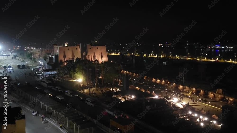 Luxor, Egypt: Nile embankment with boats and Luxor Temple in Luxor, beautiful night landscape, Egypt.