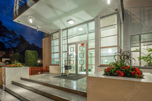 Modern exterior of luxury private house at twilight. Entrance.