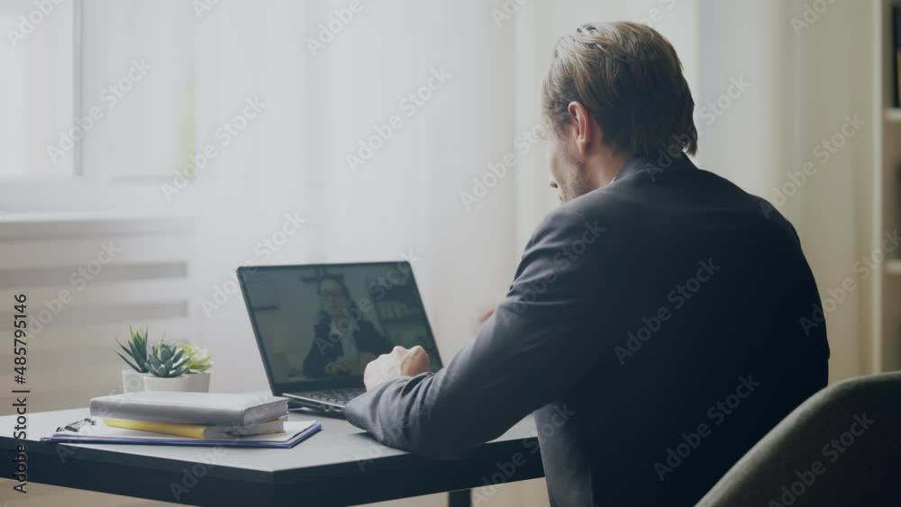Friendly male businessman having online video call with client, business meeting